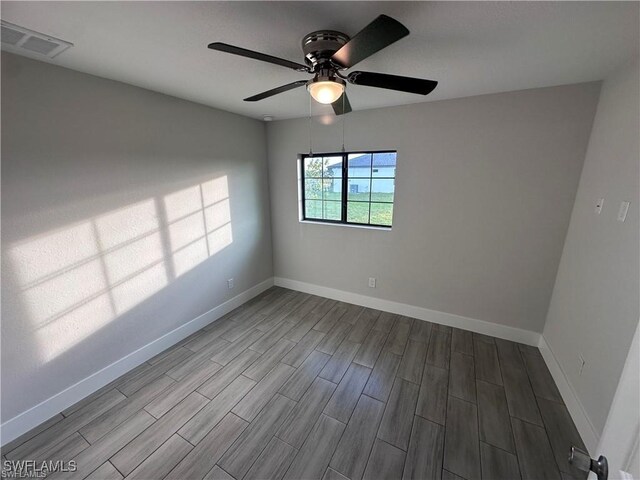 unfurnished room featuring ceiling fan, wood tiled floor, visible vents, and baseboards