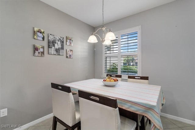 dining area featuring a notable chandelier, baseboards, and light tile patterned floors