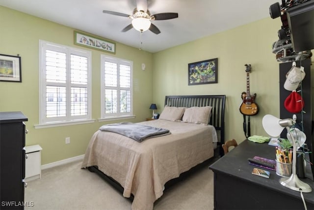 bedroom featuring light carpet, ceiling fan, and baseboards