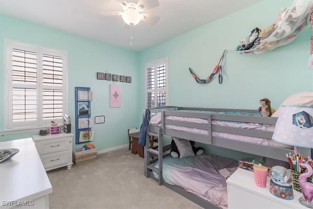 bedroom featuring baseboards, ceiling fan, and light colored carpet