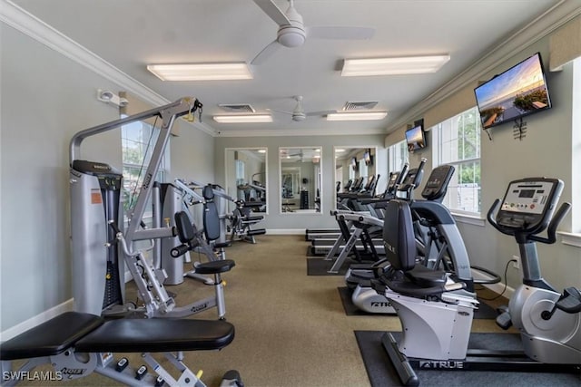 exercise room featuring baseboards, visible vents, ornamental molding, and a ceiling fan