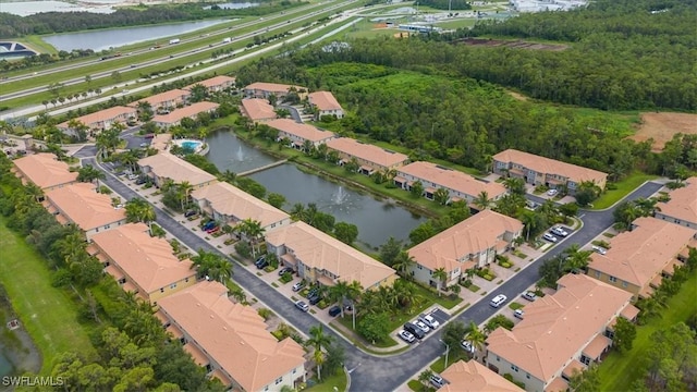 birds eye view of property with a water view and a residential view