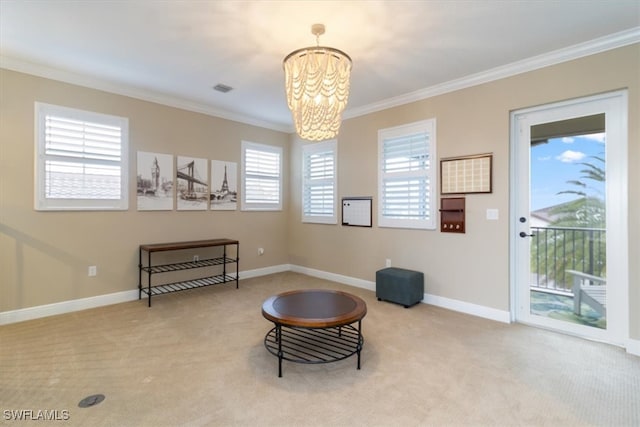 living area featuring carpet flooring, a healthy amount of sunlight, ornamental molding, and a notable chandelier