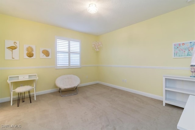 living area featuring light carpet