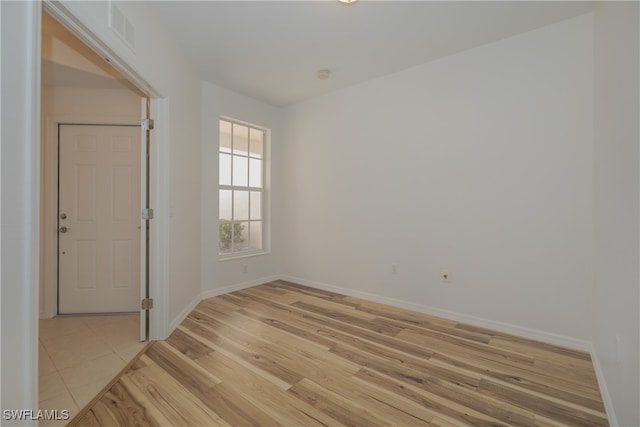 spare room with light hardwood / wood-style flooring