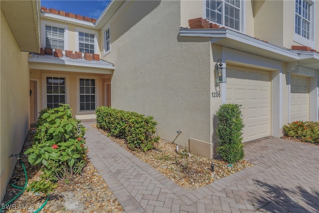 doorway to property with a garage