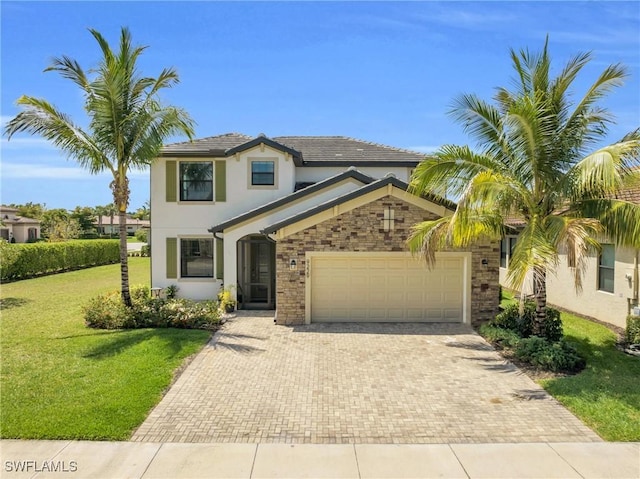 view of front of home featuring a garage and a front yard