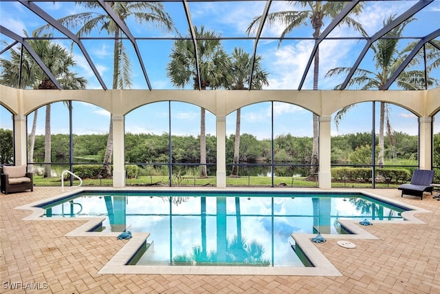 view of swimming pool featuring glass enclosure and a patio area