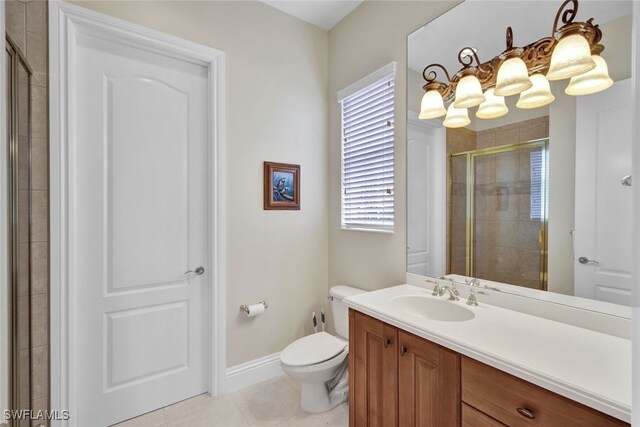 bathroom featuring tile patterned floors, vanity, a shower with shower door, and toilet