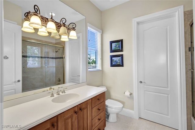 bathroom featuring tile patterned flooring, vanity, toilet, and a shower with shower door