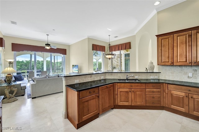 kitchen with ceiling fan, a healthy amount of sunlight, sink, and hanging light fixtures