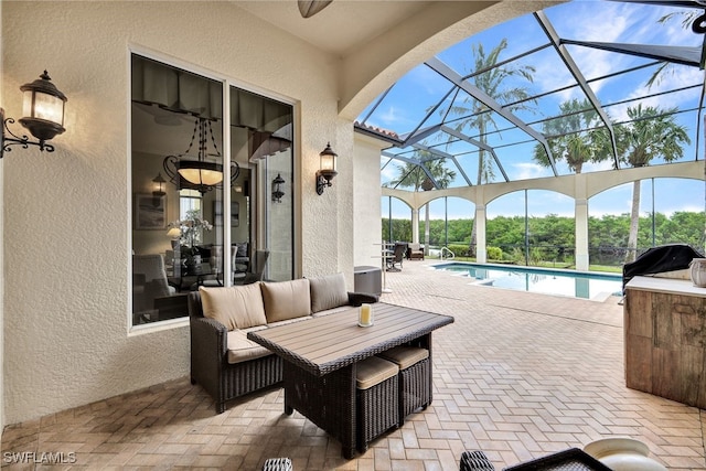 view of patio with a lanai, grilling area, and an outdoor living space