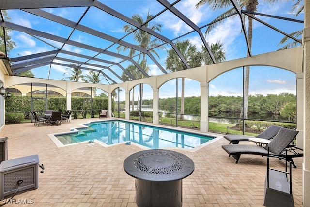 view of pool with a patio area, a lanai, and a water view