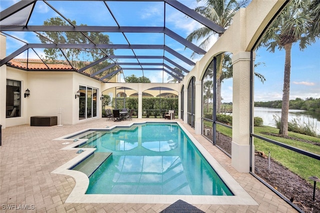 view of pool featuring a water view, a patio area, and a lanai