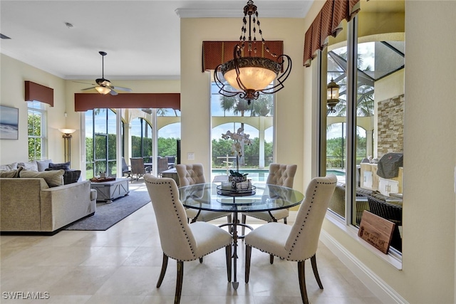 dining area with ceiling fan and ornamental molding