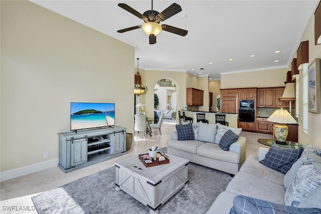 living room with ceiling fan, ornamental molding, and light tile patterned floors