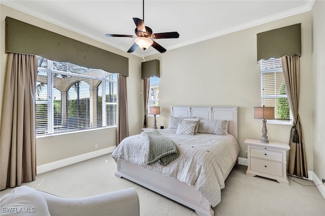 bedroom featuring ceiling fan, ornamental molding, light carpet, and multiple windows