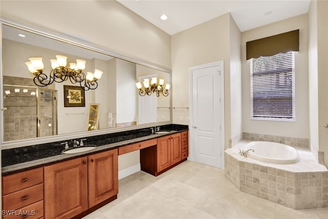 bathroom with tile patterned flooring, shower with separate bathtub, vanity, and an inviting chandelier