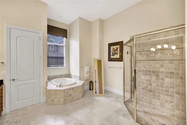 bathroom with tile patterned floors, vanity, and separate shower and tub