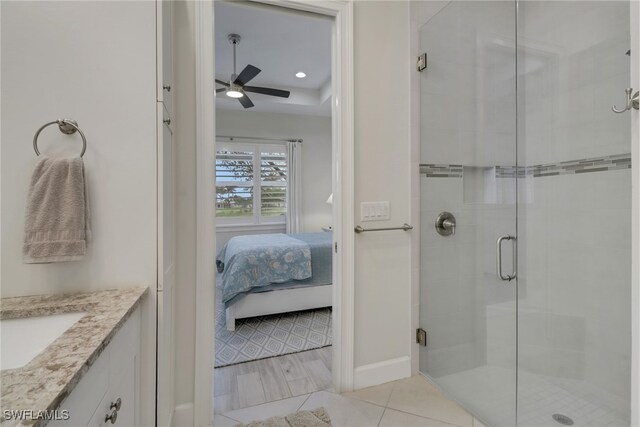 bathroom featuring vanity, hardwood / wood-style floors, ceiling fan, and a shower with shower door