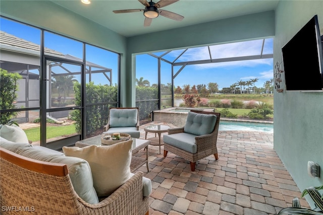 sunroom / solarium with a wealth of natural light, ceiling fan, and a pool