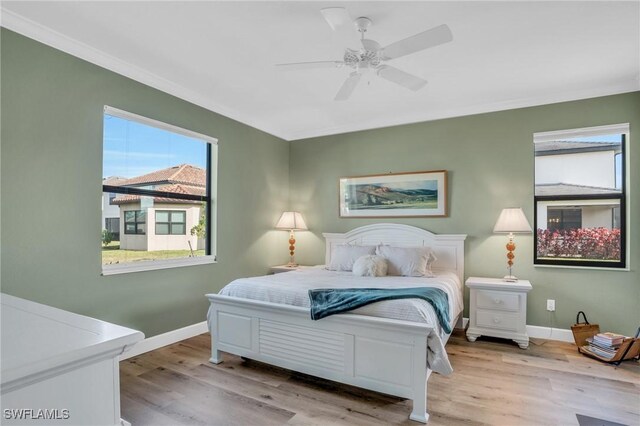 bedroom with light hardwood / wood-style flooring and ceiling fan