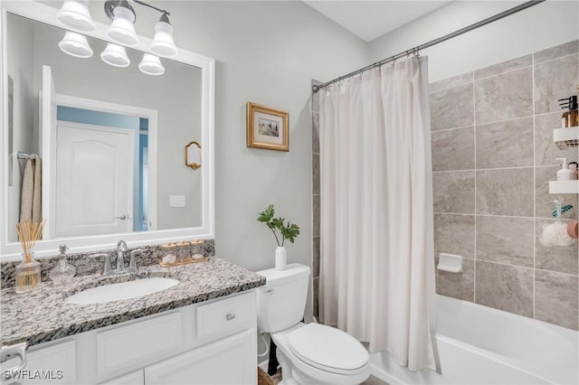 full bathroom featuring vanity, toilet, and shower / tub combo with curtain