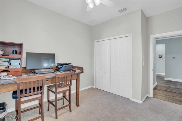 carpeted home office with ceiling fan