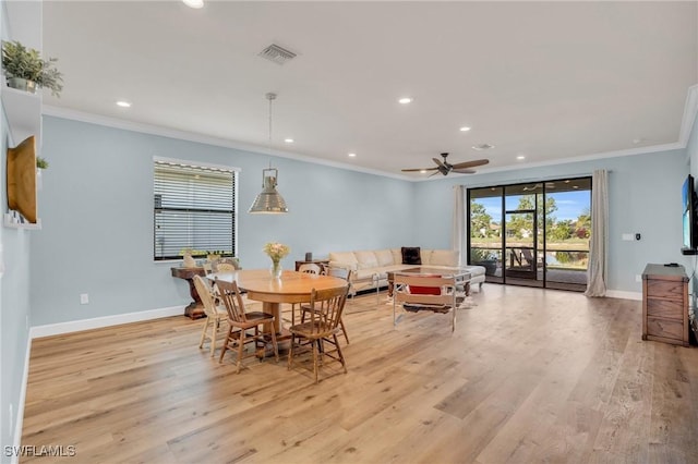 dining space with crown molding, ceiling fan, and light hardwood / wood-style floors