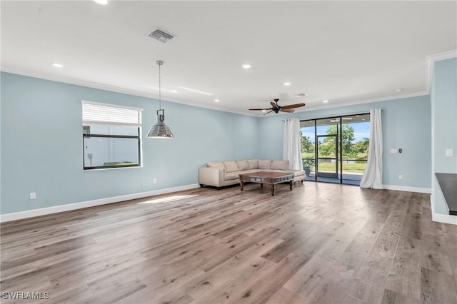 unfurnished living room featuring ornamental molding, ceiling fan, and light hardwood / wood-style floors