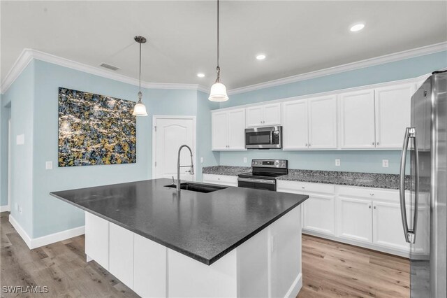 kitchen with sink, a center island with sink, white cabinets, and appliances with stainless steel finishes