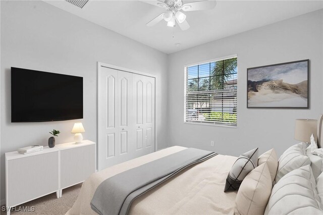 carpeted bedroom featuring a closet and ceiling fan