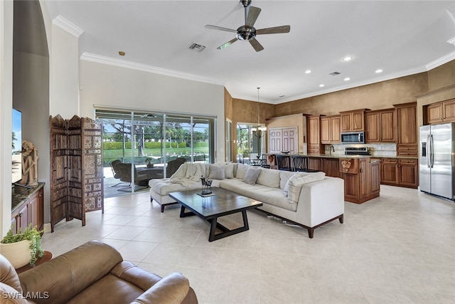 living room with ceiling fan, sink, crown molding, and light tile patterned flooring