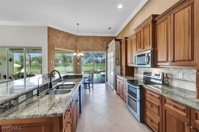 kitchen featuring a chandelier, hanging light fixtures, appliances with stainless steel finishes, light tile patterned floors, and sink