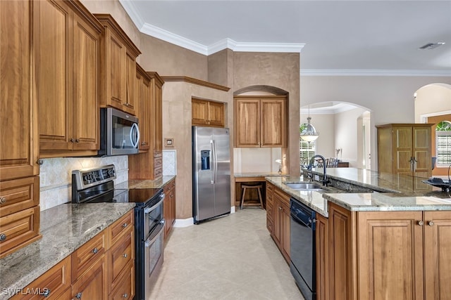 kitchen with backsplash, ornamental molding, appliances with stainless steel finishes, light stone counters, and light tile patterned floors