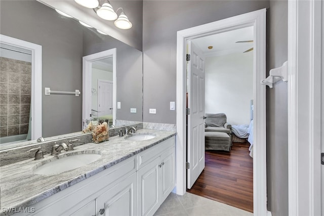 bathroom featuring shower / bathtub combination, double sink vanity, and tile patterned floors