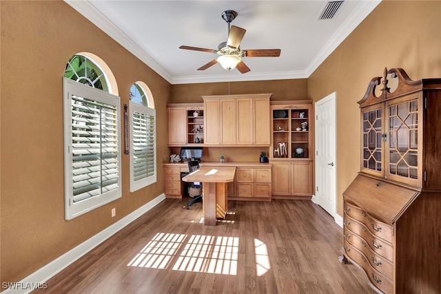 office with ceiling fan, dark hardwood / wood-style floors, built in desk, and crown molding