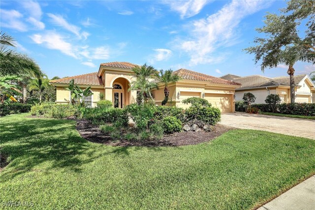 mediterranean / spanish house featuring a front lawn and a garage