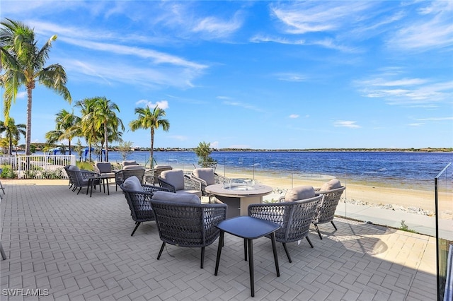 view of patio featuring a beach view and a water view