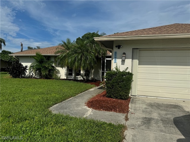 view of front of home featuring a garage and a front lawn