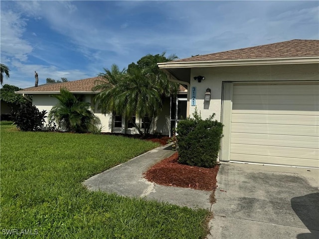 view of front of property with a shingled roof, a front yard, an attached garage, and stucco siding