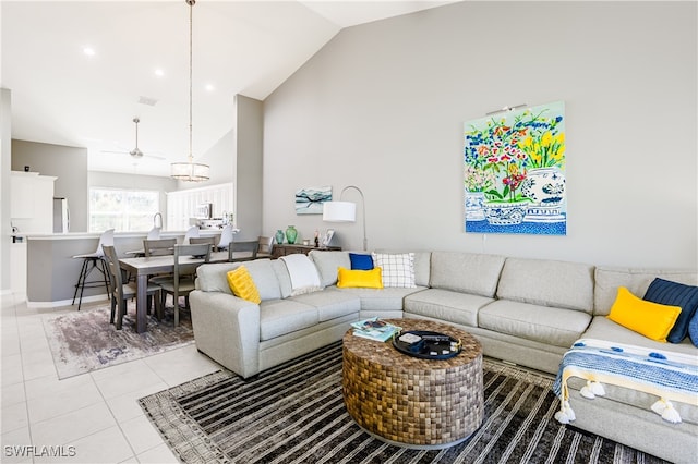 living room featuring high vaulted ceiling and light tile patterned floors