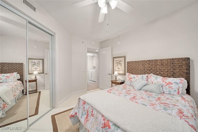 bedroom featuring ceiling fan, washer / clothes dryer, and light carpet