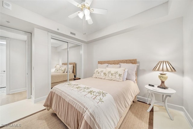 bedroom with ceiling fan and a closet