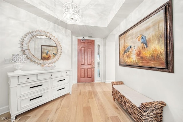 corridor featuring light hardwood / wood-style flooring and a chandelier