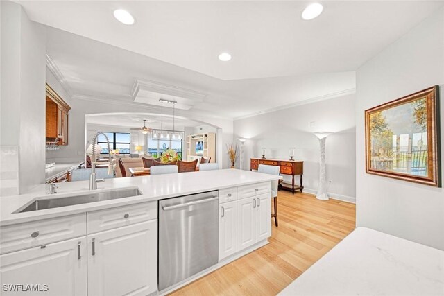 kitchen with light hardwood / wood-style flooring, stainless steel dishwasher, sink, crown molding, and white cabinets