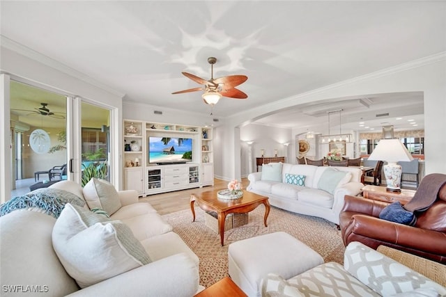 living room with crown molding, ceiling fan, and light hardwood / wood-style flooring