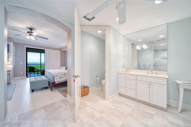 bathroom featuring ceiling fan, toilet, tile patterned flooring, vanity, and ornamental molding