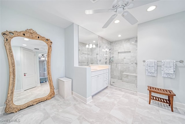 bathroom featuring ceiling fan, vanity, tiled shower, and tile patterned floors