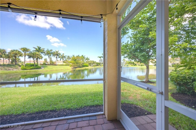 unfurnished sunroom with a water view